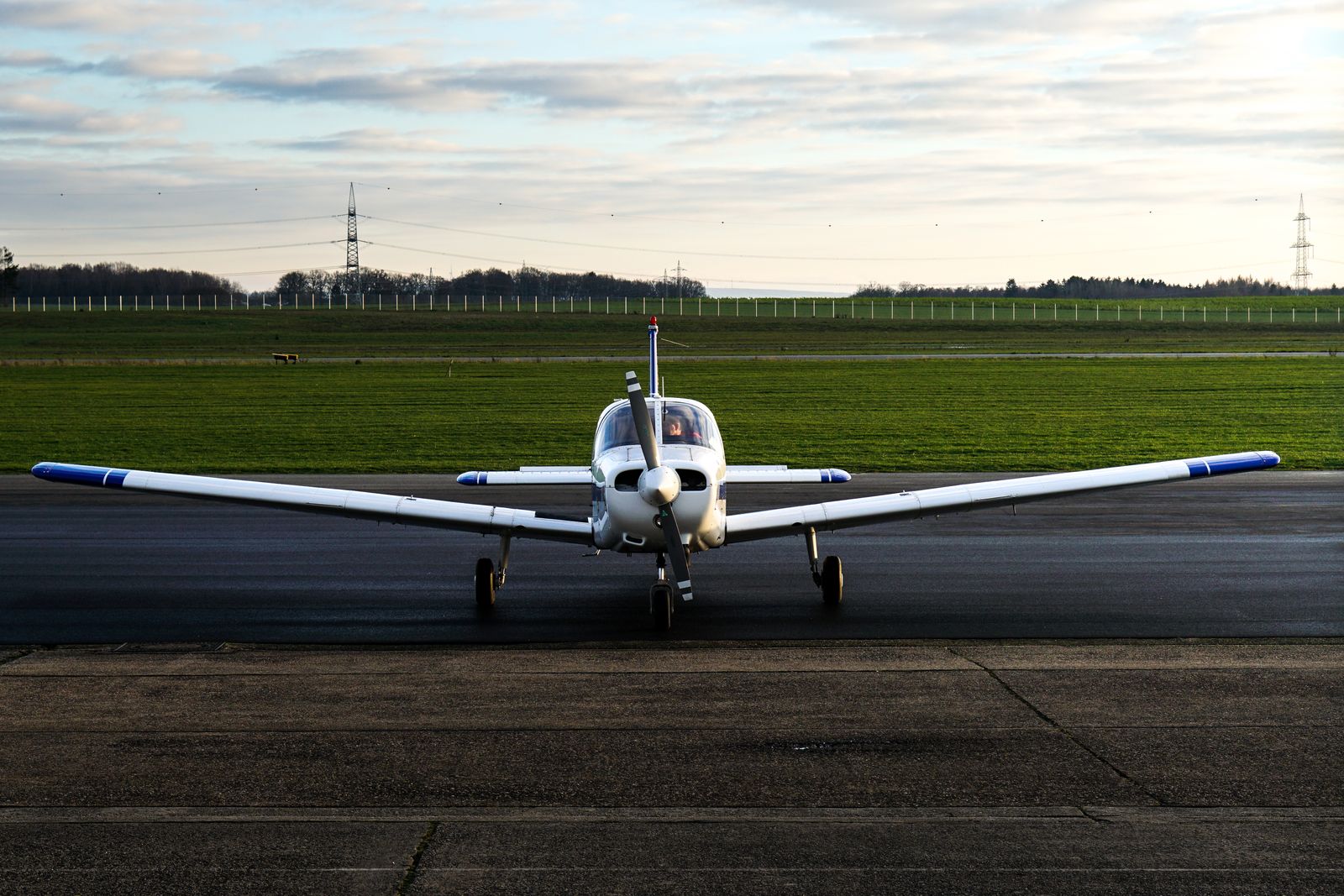 Airplane on the runway of a small airport at sunset